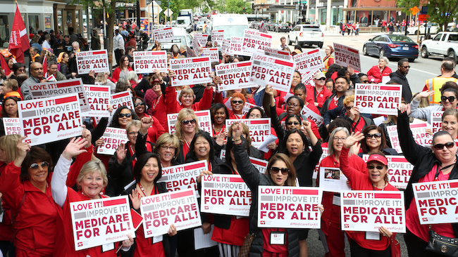 Nurses hold signs calling for Medicare for All