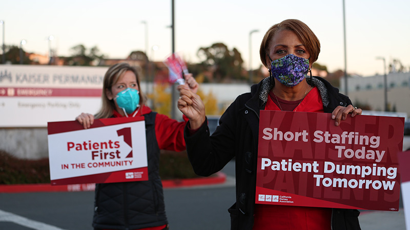 Nurses outside hold signs "Short staffing today, patient dumping tonmorrow"