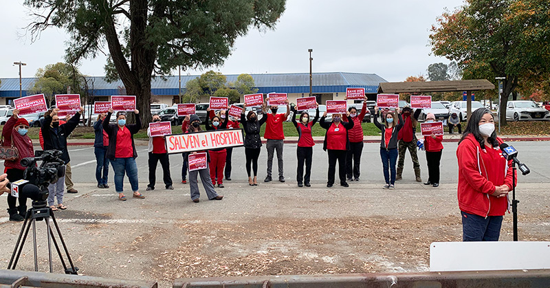 Large group of nurses outside hold press conference