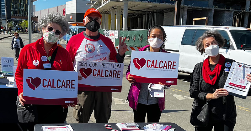 Group of four people holding CalCare signs