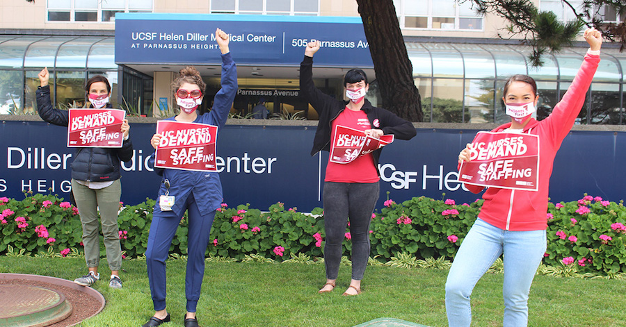 Nurses outside hospital hold signs calling for safe staffing