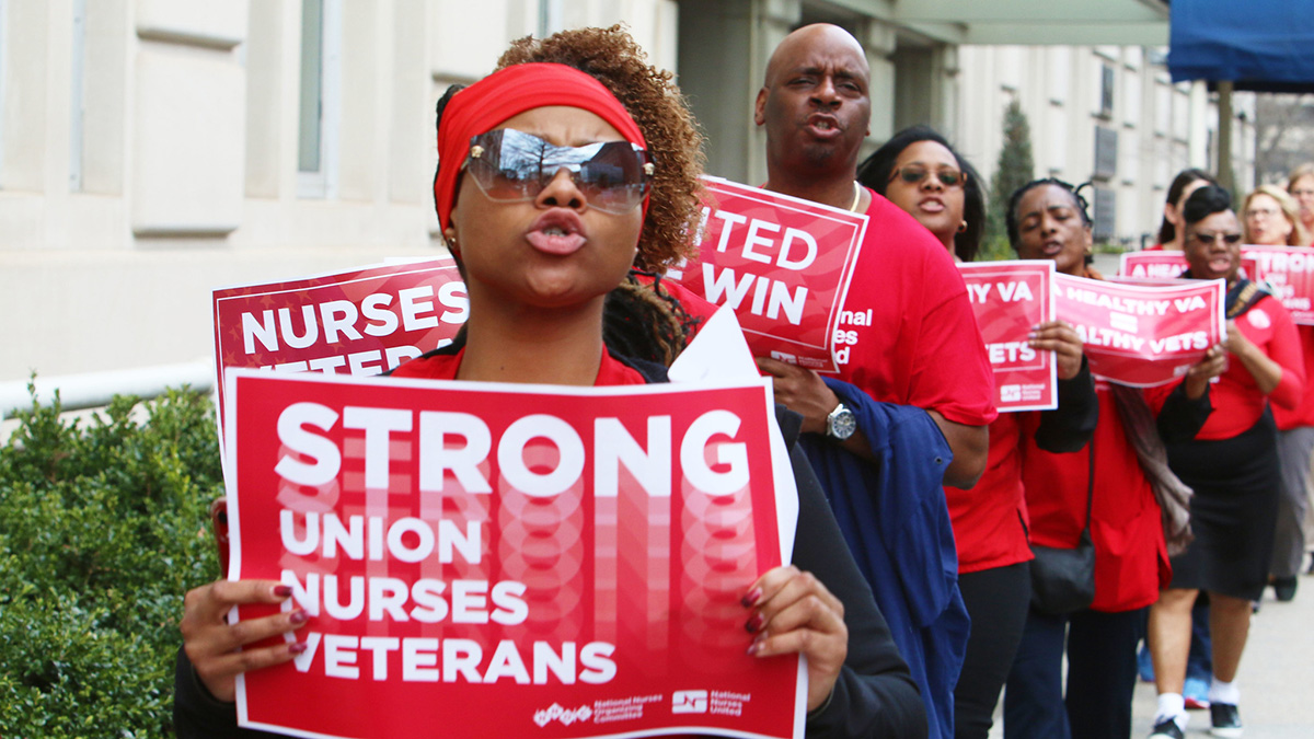 Nurses hold signs "Strong Union, Nurses, Veterans"