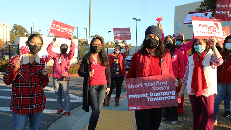 Nurses holding signs "Short Staffing Today, Patient Dumping Tomorrow"