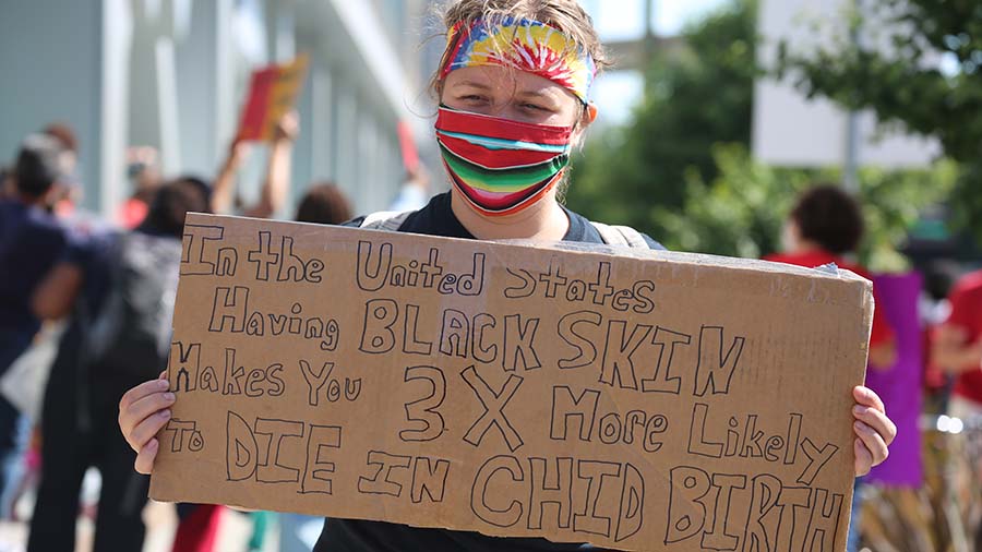 Nurse holds sign