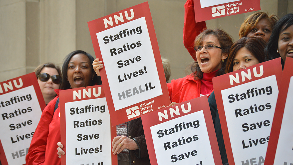 Nurses hold signs: "Staffing Ratios Save Lives!"