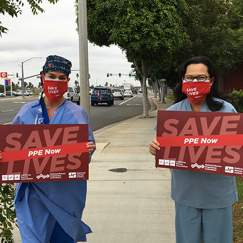 Nurses hold signs "PPE Now"