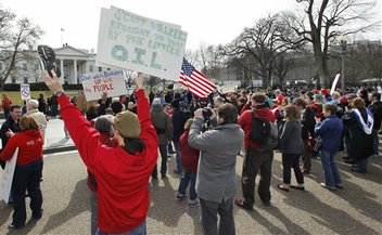 Protestors hold signs