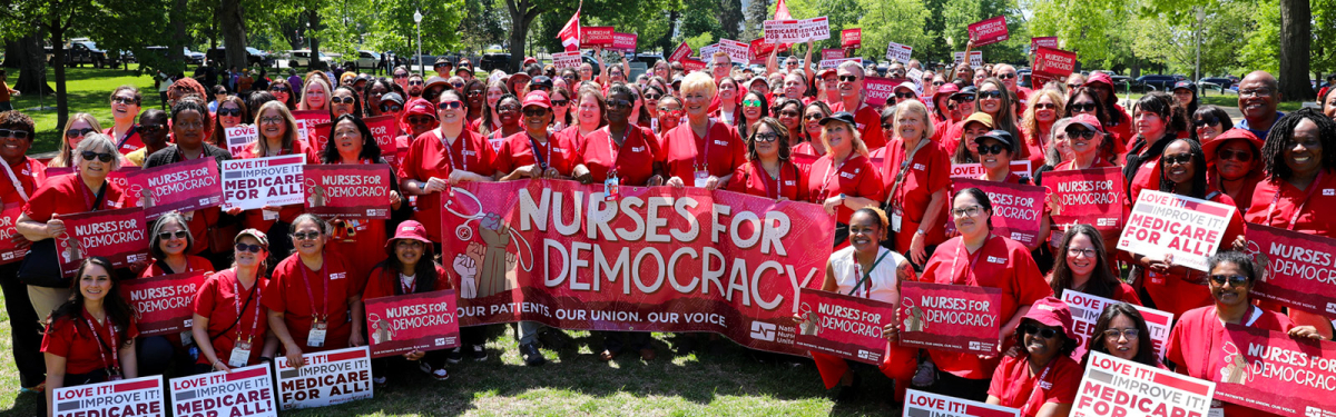 Large group of nurses holding banner "Nurses for Democracy"