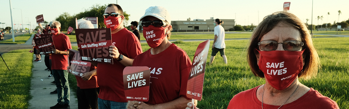 Nurses hold signs "Protect nurses"