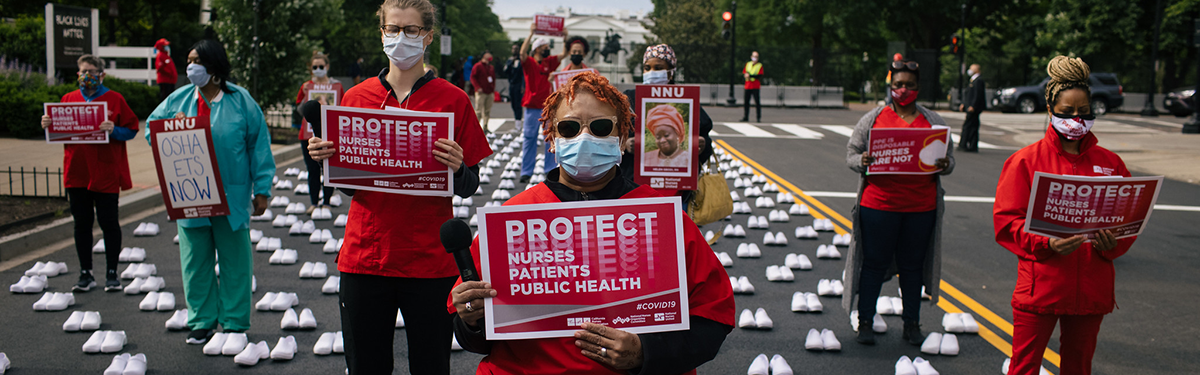 Nurses hold signs "Protect nurses, patients, and public health"