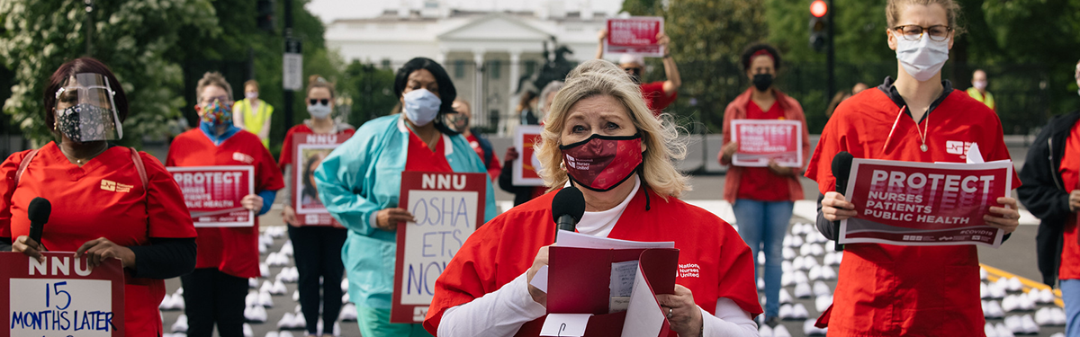Nurses hold signs calling for Covid-19 protection outside the Whitehouse