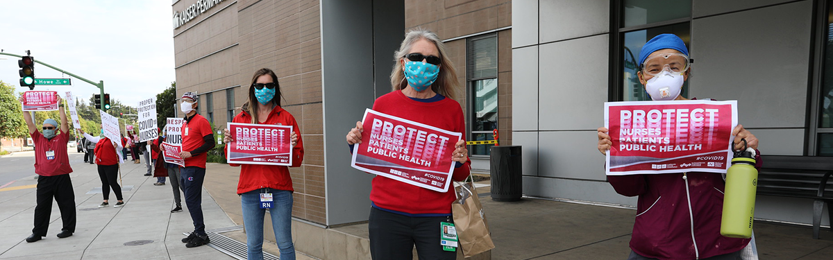 Nurses hold signs "Protect nurses"