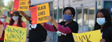 Nurses hold "Black Lives Matter" signs