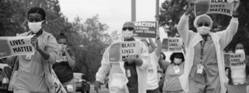Nurses hold "Black Lives Matter" signs