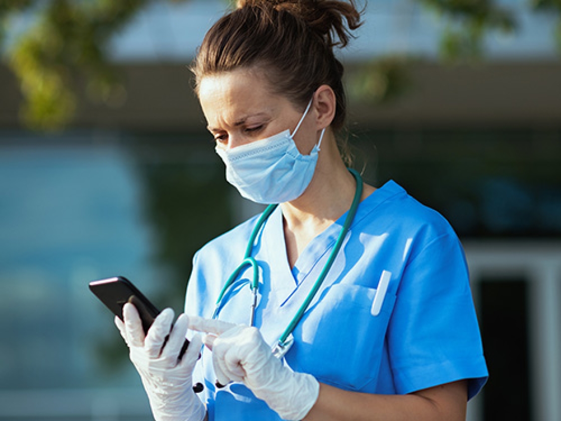 Nurse looking at smartphone