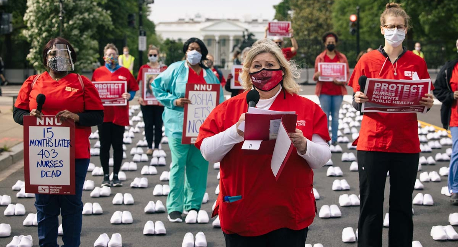 Nurses outside The Whitehouse holds signs calling for protection from Covid-19