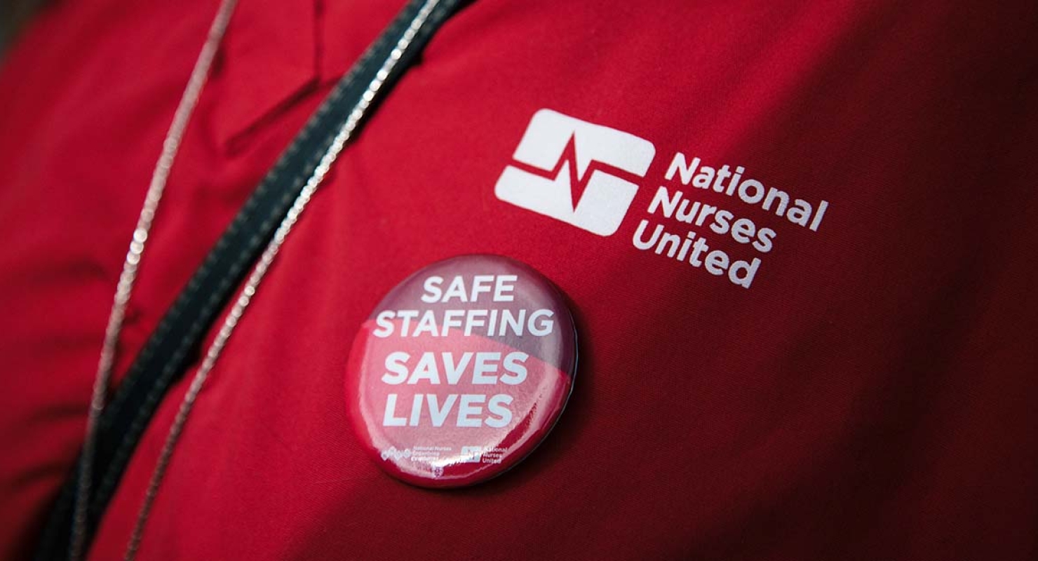 Button on nurses chest reads "Safe Staffing Saves Lives"