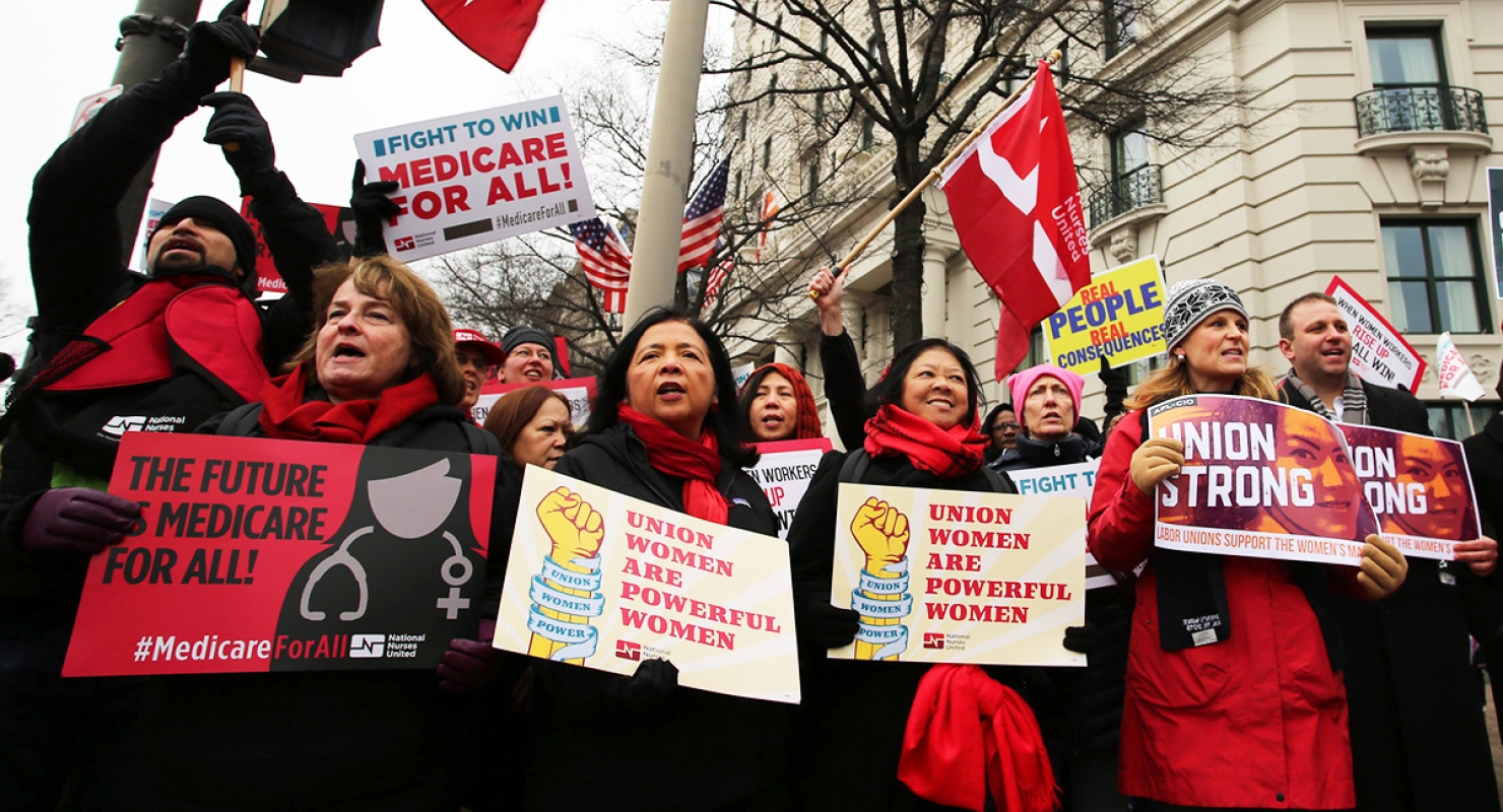Nurses at march hold signs "Union Women are Powerful Women"