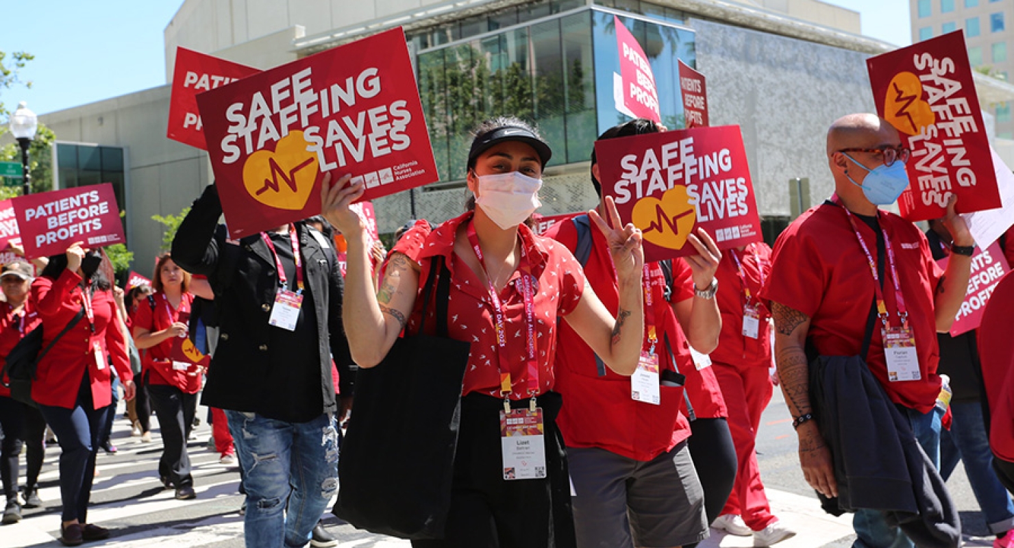 Nurses hold signs calling for safe staffing