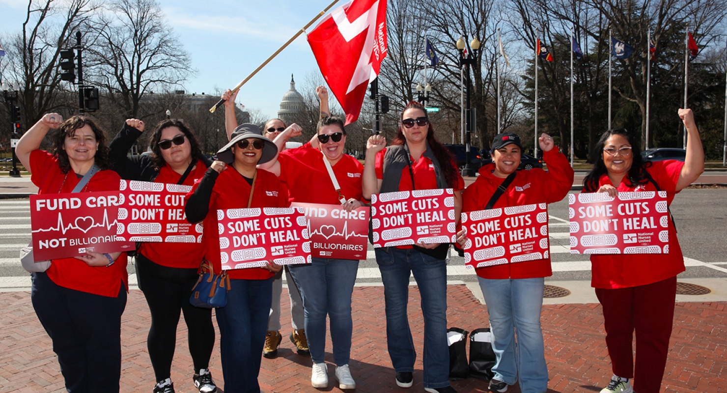 Nurses holding signs "Some Cuts Don't Heal"