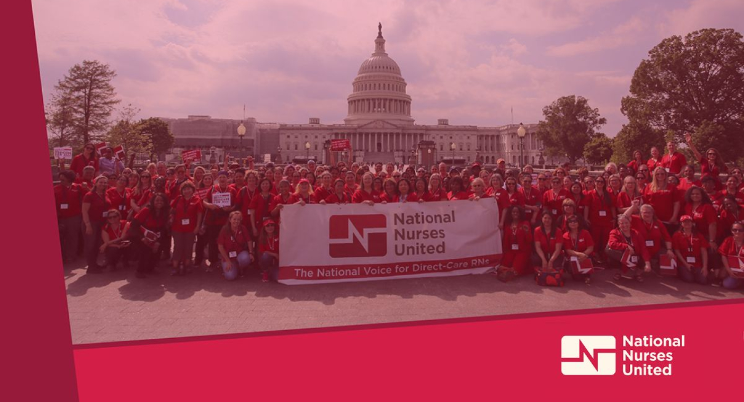Large group of nurses behind NNU banner