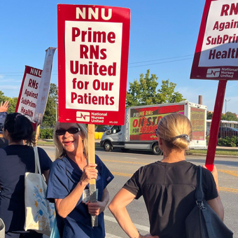 Nurses on picket line holding signs "Prime RNs United for Our Patients"