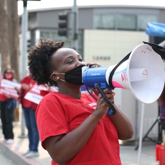 Nurse holding bullhorn outside