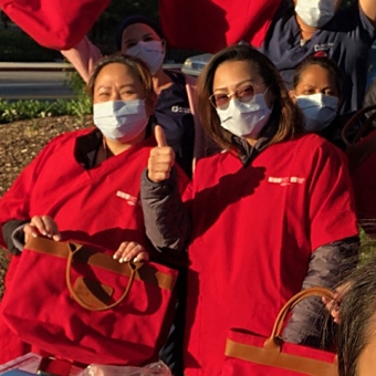 Nurses outside giving thumbs up