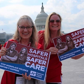 Nurses hold signs calling for safer workplaces