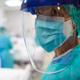 Nurse inside hospital wearing face shield