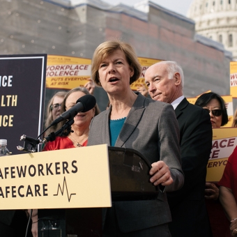 Senator Tammy Baldwin at podium outside Capitol Building