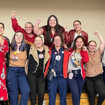 Joyous Saint Agnes nurses with fists raised