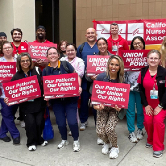 Group of nurses holding signs "Our Patients, Our Union, Our Rights"