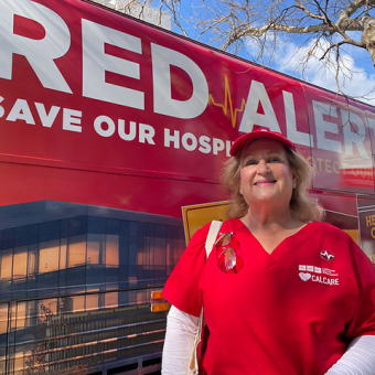 Nurse in front of Red Alert tour bus