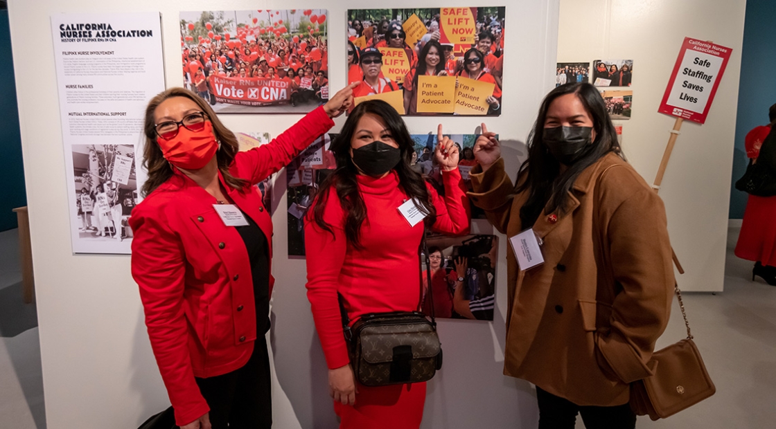 Nurses standing in front of art exhibit