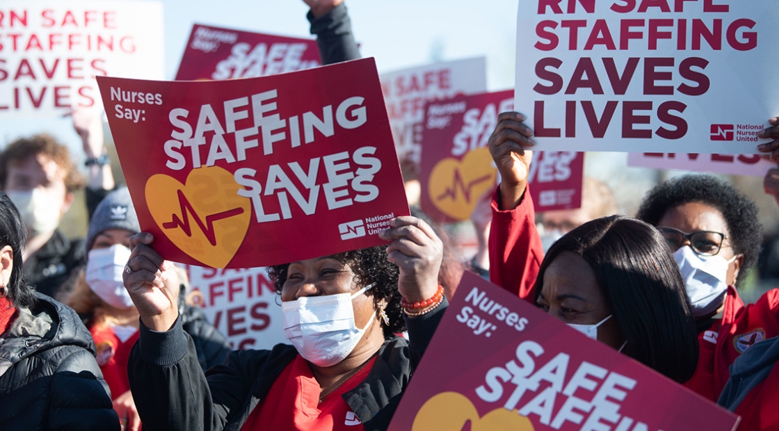 Nurses holding signs "Safe Staffing Saves Lives"