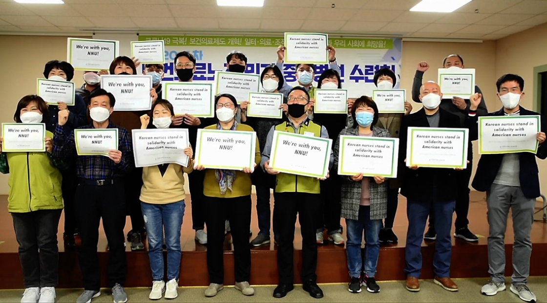 Korean nurses holding signs calling for global solidarity