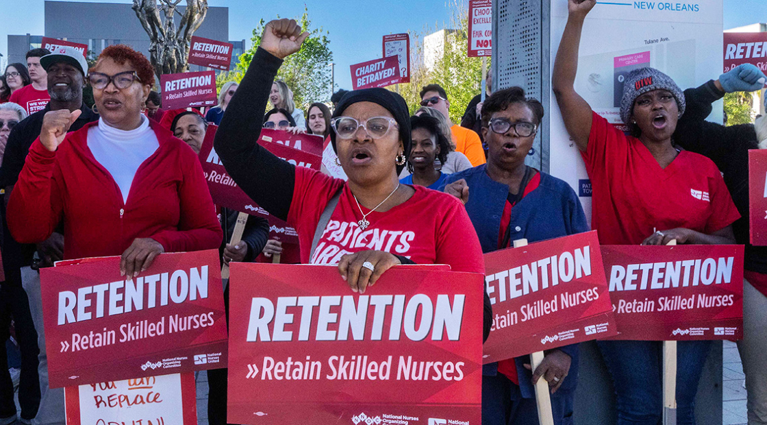 Nurses on picket line with raised fists and holding signs "Retention: Retain Skilled Nurses"