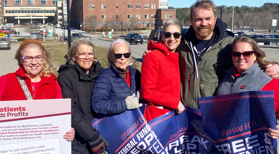 Nurses with Graham Platner, holding signs of support
