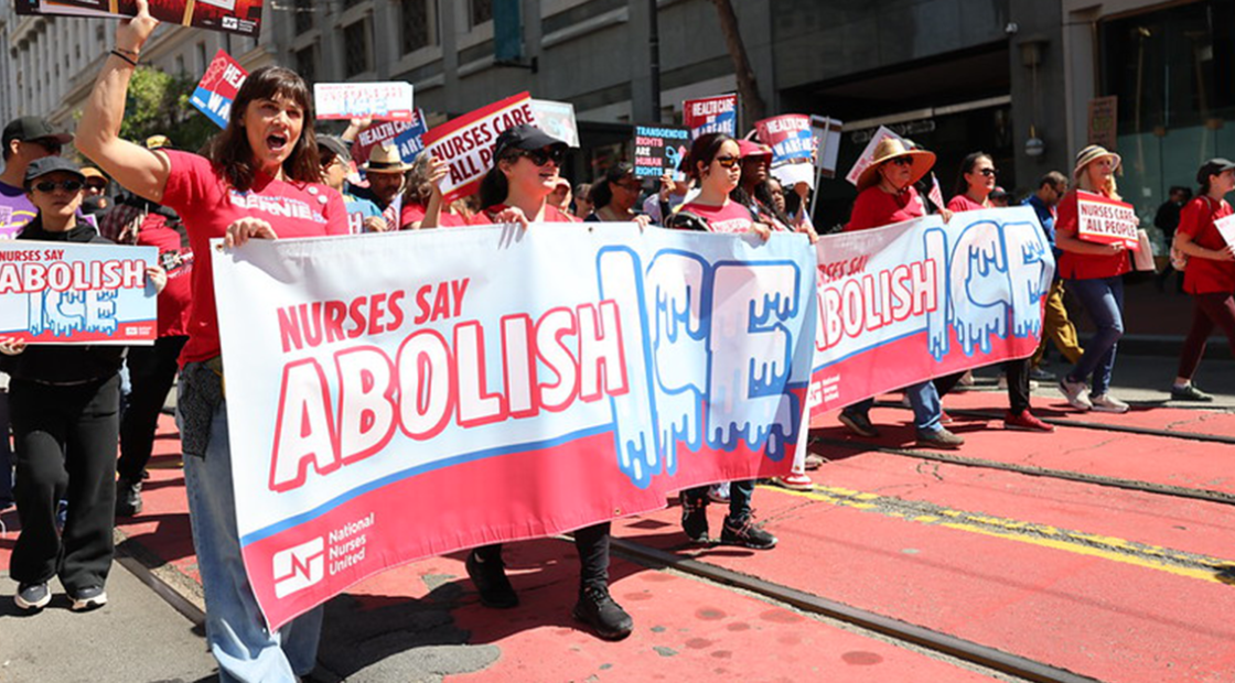 Nurse hold "Nurses say abolish ICE!" banner at rally