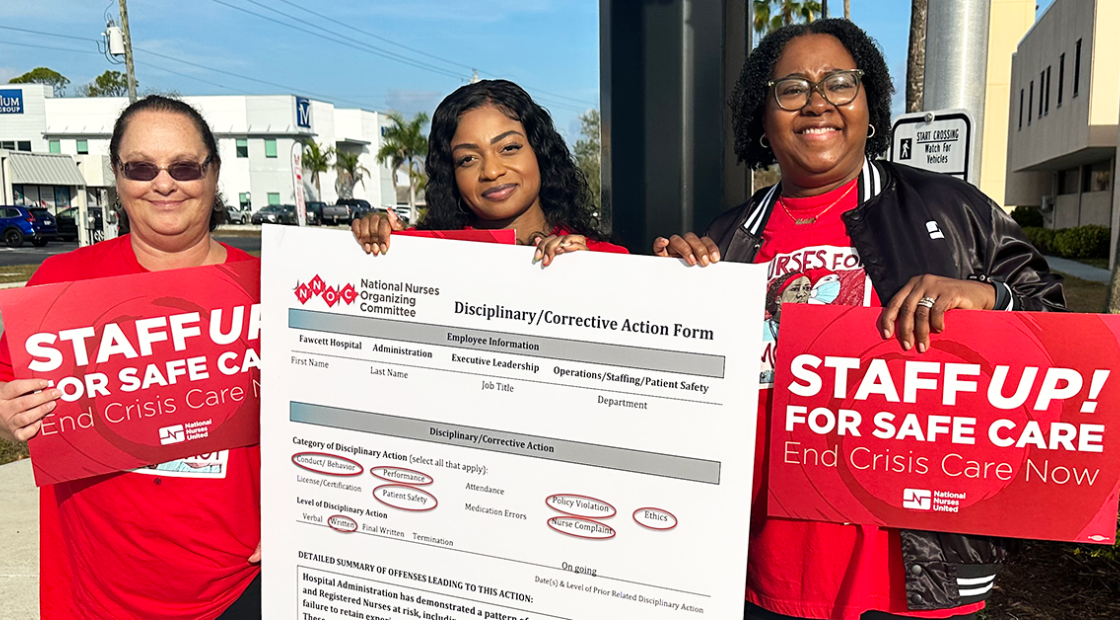 Three nurses holding signs "Staff up for safe care: End crisis care now" and a huge disciplinary/corrective action form