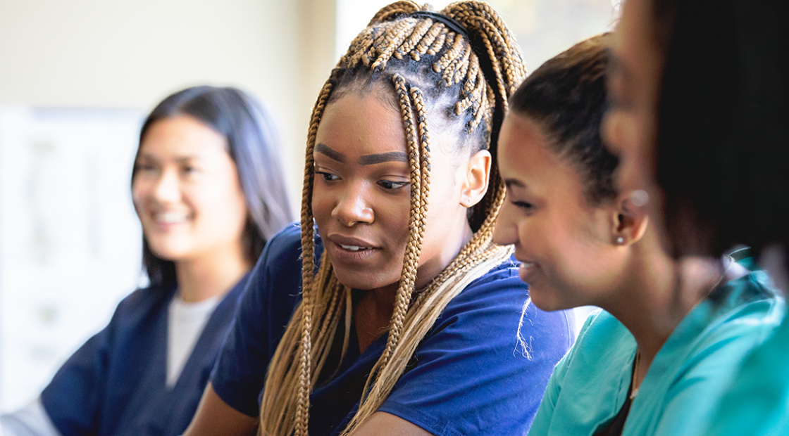 Student nurses looking at work together.