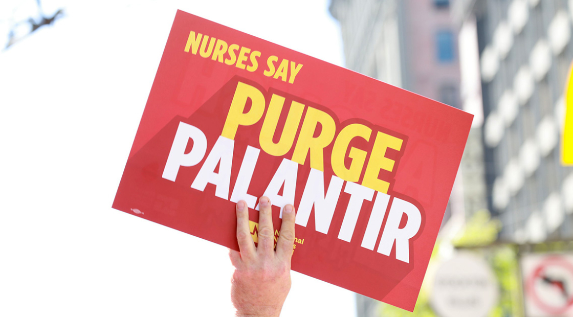 Hand holding sign '"Nurses Say Purge Palantir"