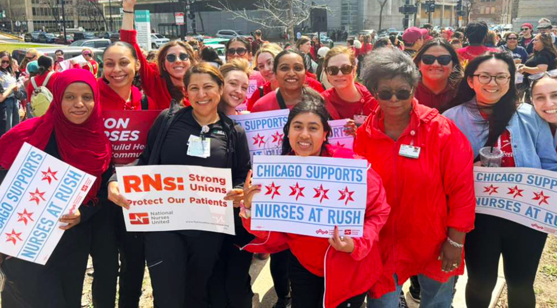 Group of nurses outside, smiling, holdinhg signs "Chicago Supports Nurses at Rush"