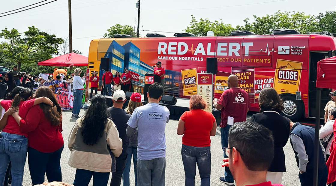 Community at Red Alert Tour stop with red alert bus in background