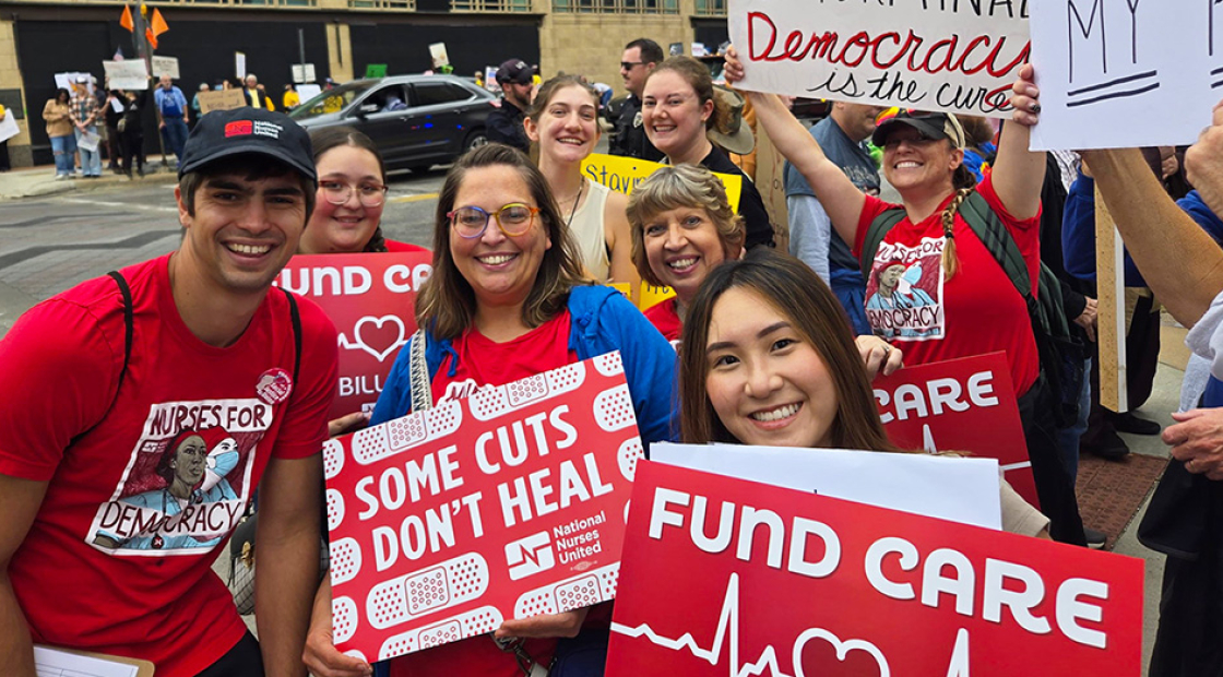 Group of nurses in No Kings march, holding signs "Fund Care, NOT Billionaires"