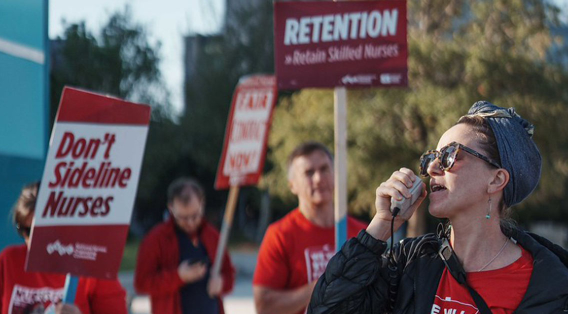 UMC nurses on strike with picket sign that reads "Don't sideline nurses."
