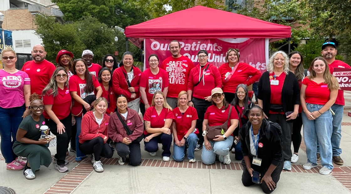 Large group of nurses posing, smiling, wearing red.