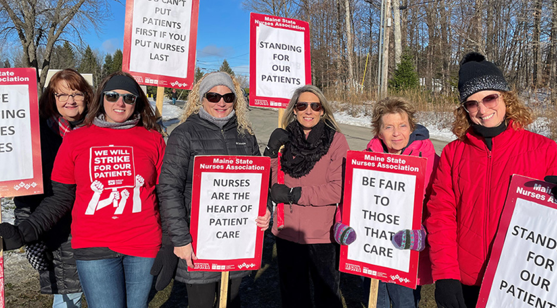 Group of nurses on picket line holding signs