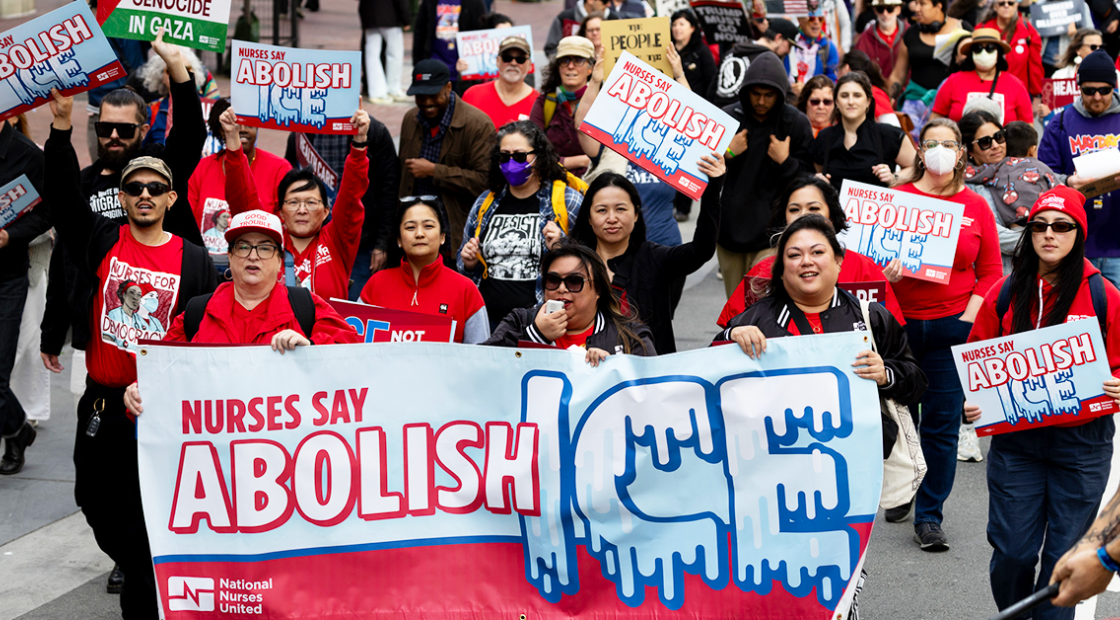 Nurses marching with Abolish ICE banners and signs.